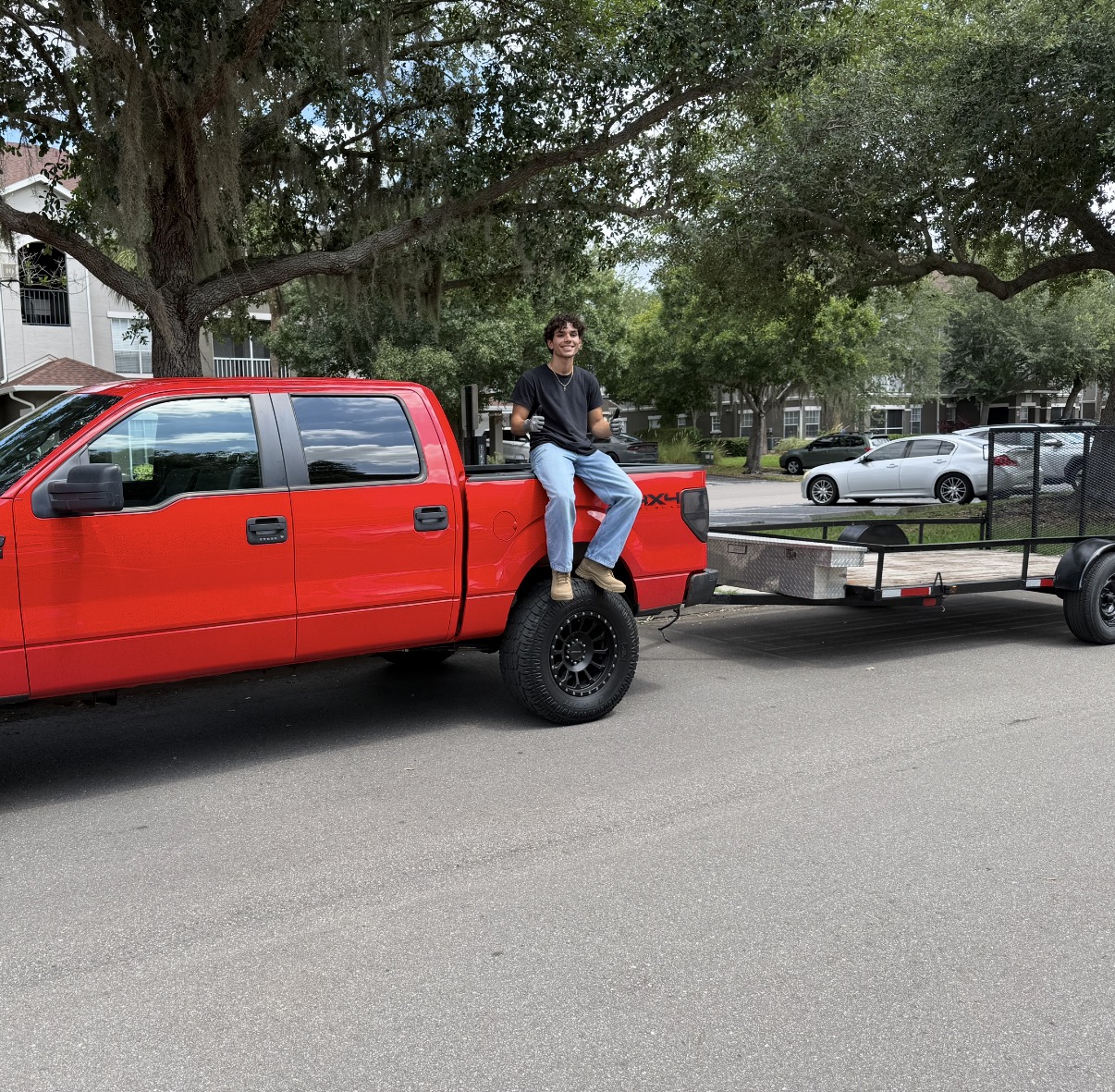 Trash Banditz red truck and trailer in Tampa Bay